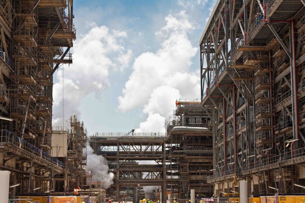 Large industrial facility under construction with scaffolding