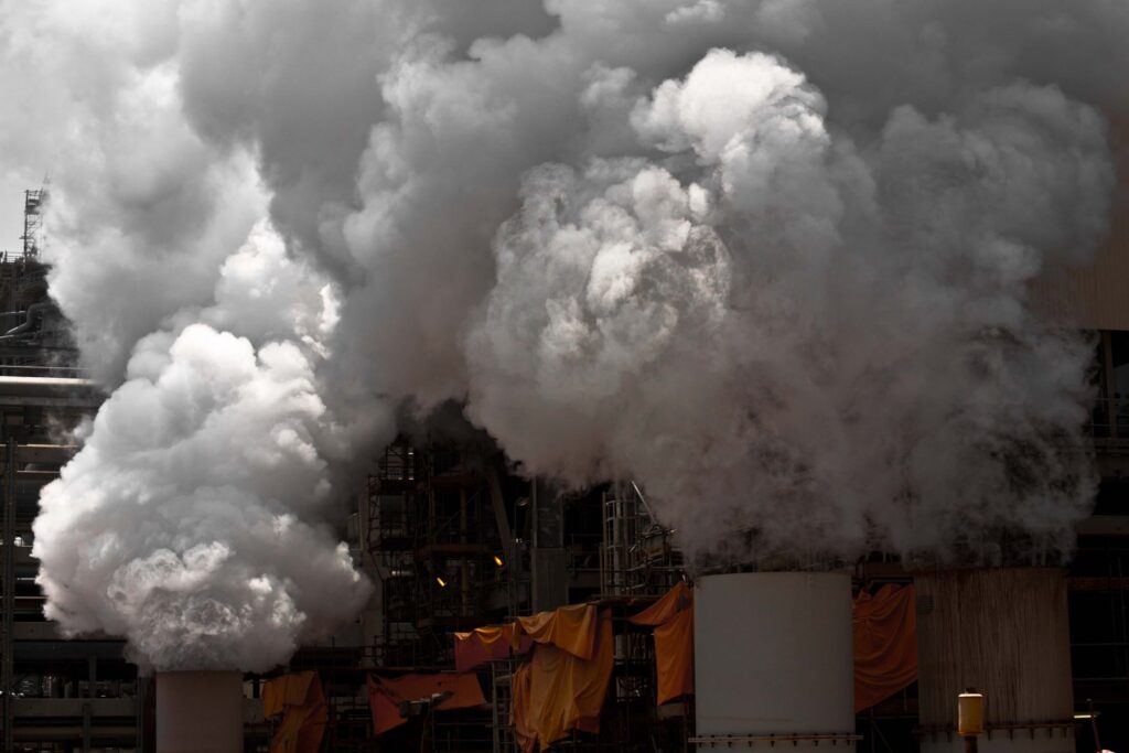 Industrial plant producing plumes of steam and smoke
