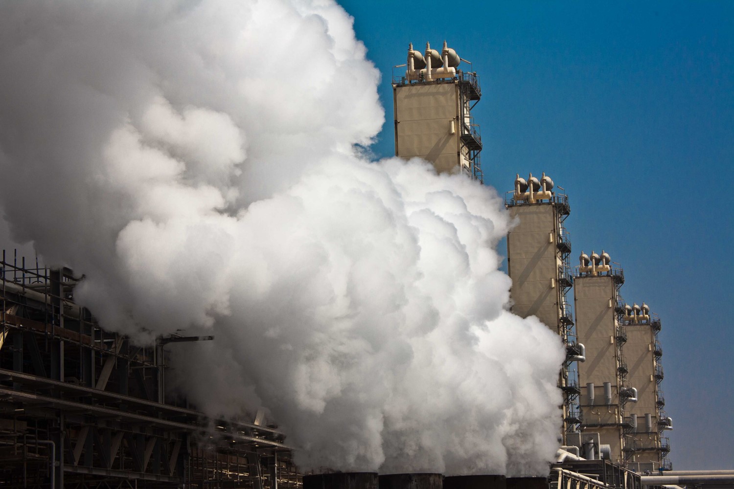 Industrial plant releasing steam and smoke